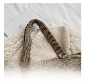 Detailed close-up of the corduroy tote bag handle with high-quality reinforced stitching