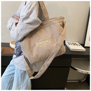 Close-up of light brown corduroy tote bag featuring embroidered Fashionly-1980 logo patch