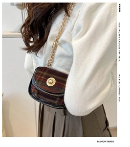 Close-up of retro plaid wool purse featuring gold buckle and metallic chain strap