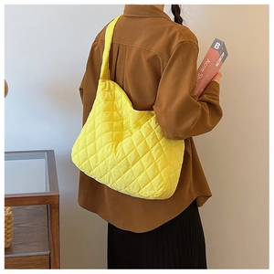 Détail d'un sac à bandoulière matelassé jaune vif avec une grande capacité de stockage