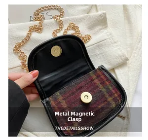 Detail showing the magnetic snap closure and golden chain on this vintage plaid handbag