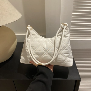 White quilted crossbody underarm bag with gold metal rings and elegant glossy fabric