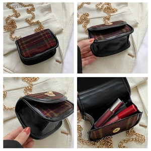 Detail of vintage plaid mini crossbody bag with gold chain strap and luxury leather trim