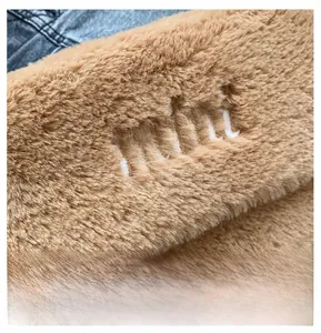 Détail en peluche marron douce avec broderie mini blanche et accent de tissu denim
