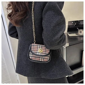 Mini plaid crossbody bag with gold chain strap shown on model in retro British style