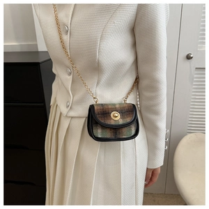 Detail of vintage plaid tweed mini bag with gold twist lock and chain strap for women
