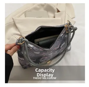 Top view of quilted shoulder bag interior showing large capacity for phone and wallet