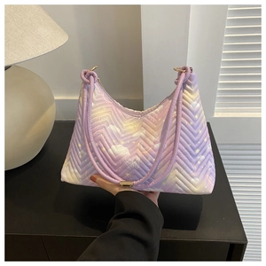 Detail of lavender quilted shoulder bag featuring dreamy star and butterfly prints