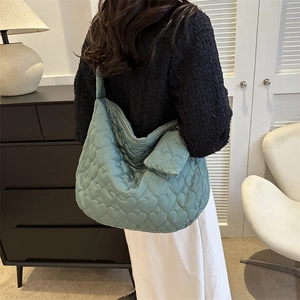 Quilted mint green tote bag featuring heart pattern stitching and matching mini coin purse
