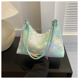 Detail of mint green chevron quilted handbag with butterfly and rainbow prints