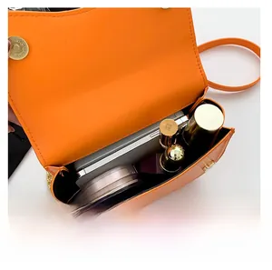Top view of open orange saddle bag showing large storage for phone and cosmetics