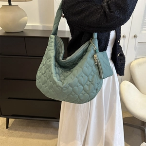 Close-up of heart-quilted pattern on Morandi blue tote bag with matching small coin pouch