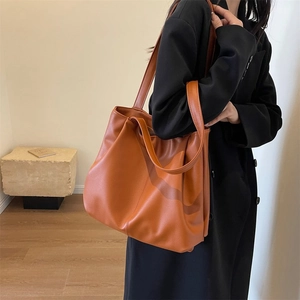 Chic caramel leather tote bag with large capacity for women in a minimalist style