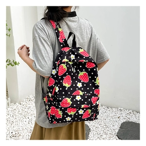Detailed back view of a student backpack featuring cute strawberry and daisy floral patterns