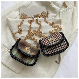 Detail of vintage plaid mini square bags with gold chain straps and metal buckle closures