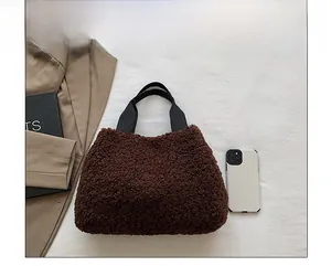 Brown fuzzy tote bag size comparison with smartphone showing spacious inner capacity
