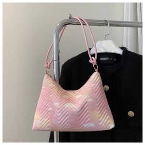 Detail of pink gradient quilted shoulder bag with butterfly and cloud prints