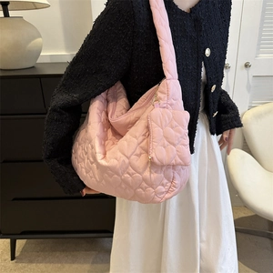 Detailed view of pink quilted heart tote bag with matching mini coin purse and zip closure