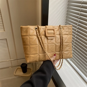 Light yellow quilted tote bag with gold chain strap and square buckle detail