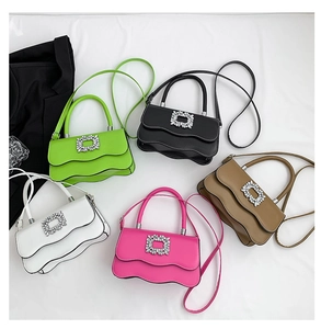 Détail de cinq sacs à main en cuir de différentes couleurs avec boucle de luxe en strass