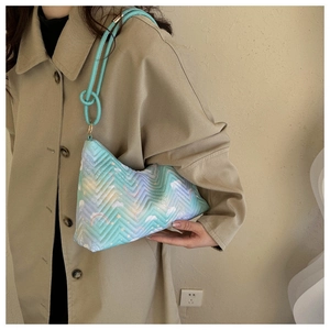 Detail of light blue rainbow quilted shoulder bag with cloud and butterfly prints
