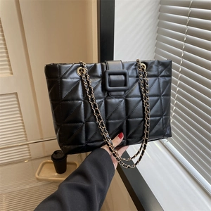 Large black quilted tote bag with gold chain strap and elegant square buckle closure