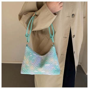Detail of mint green gradient quilted shoulder bag with cloud prints and gold hardware