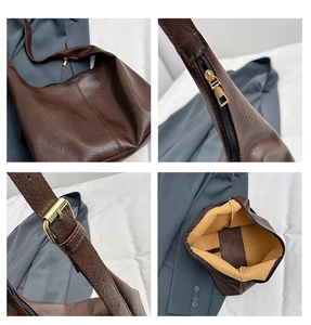 Detail view of large brown vintage tote bag showing zipper, strap buckle, and inner lining