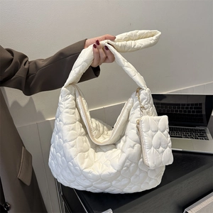 White quilted tote bag with heart pattern featuring a matching small pouch charm
