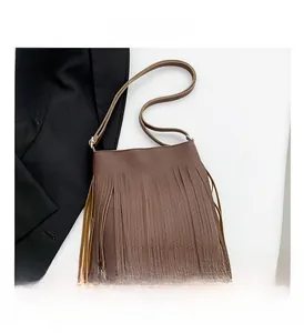 Detailed macro view of the brown fringe crossbody bag with litchi textured leather material