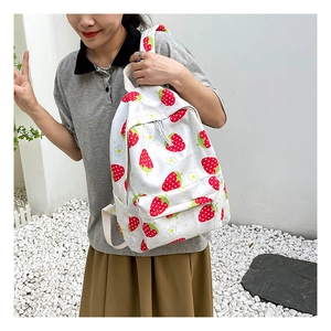 Asian model wearing a white school backpack with cute strawberry and flower patterns