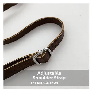 Detail of adjustable dark brown litchi grain leather strap with polished silver buckle