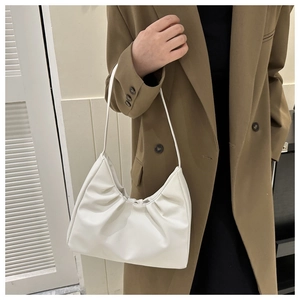Detail view of white ruched shoulder bag with soft PU leather texture and pleated design