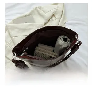 Macro view of spacious interior of dark brown leather tote bag showing large capacity