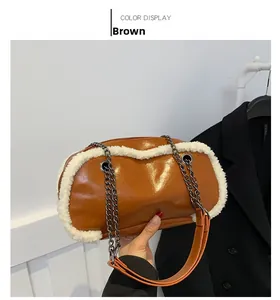 Detail of a brown pillow bag featuring soft white faux fur trim and metal chain strap