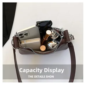 Vue de dessus de l'intérieur d'un sac en cuir marron avec portable et cosmétiques