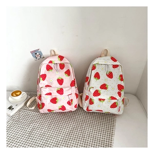Detail of cute strawberry and daisy patterns on a large capacity pink student backpack