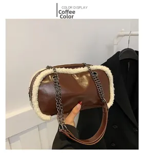 Detail of coffee brown shoulder bag with white faux fur trim and metal chain strap