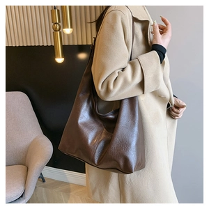 Detailed view of deep brown large capacity faux leather hobo bag for daily commuting
