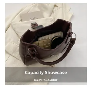 Brown leather handbag interior showing wallet and cosmetics with magnetic closure