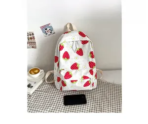 Size comparison of white strawberry print backpack with smartphone and coffee cup