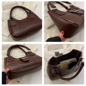 Detail view of brown faux leather handbag showing dual handles and interior storage