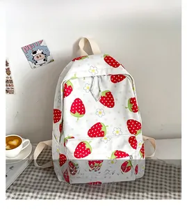 Detailed close-up of fresh strawberry and floral print on white canvas backpack