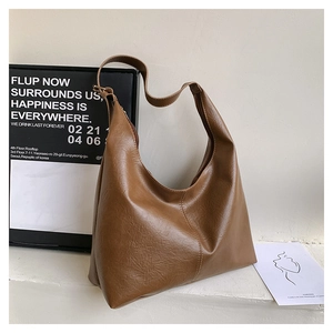Detail view of brown faux leather hobo bag showing textured finish and stylish seam