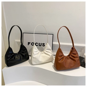 Detailed view of ruched shoulder bags in black, white, and brown with soft leather texture