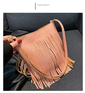 Detail view of the pink fringe shoulder bag featuring premium lychee grain leather texture