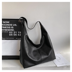 Detailed view of black Hobo bag with soft PU leather texture and gold zipper closure