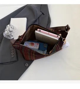Spacious interior of red and green plaid tote bag holding tablet and daily essentials