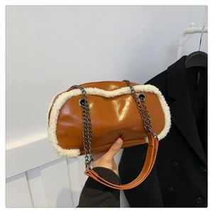 Detailed shot of brown PU shoulder bag with white faux fur trim and vintage chain strap