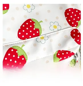 Close-up of precise stitching and strawberry print details on the canvas backpack